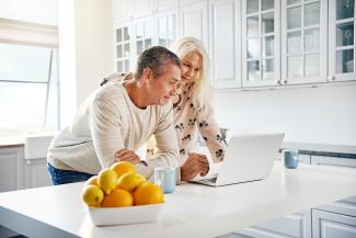 Healthy happy retired couple browsing the internet